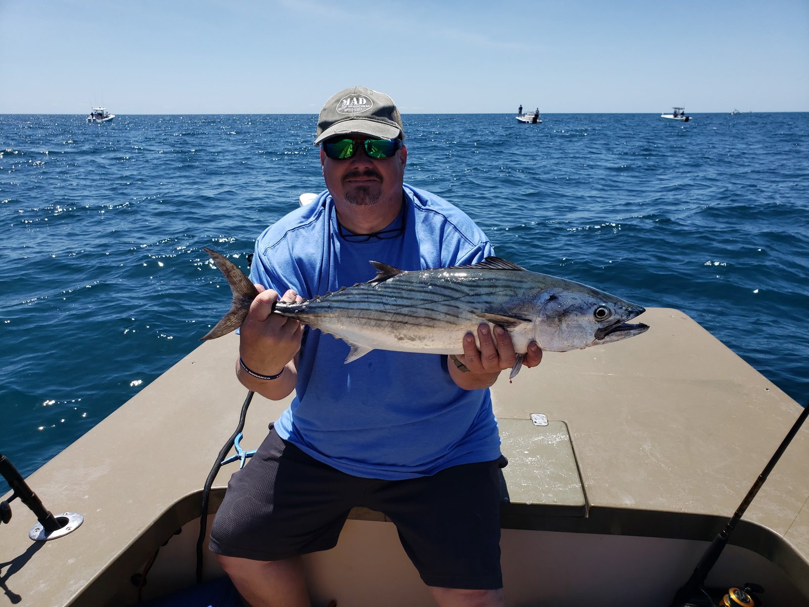 Angler holding a large fish offshore